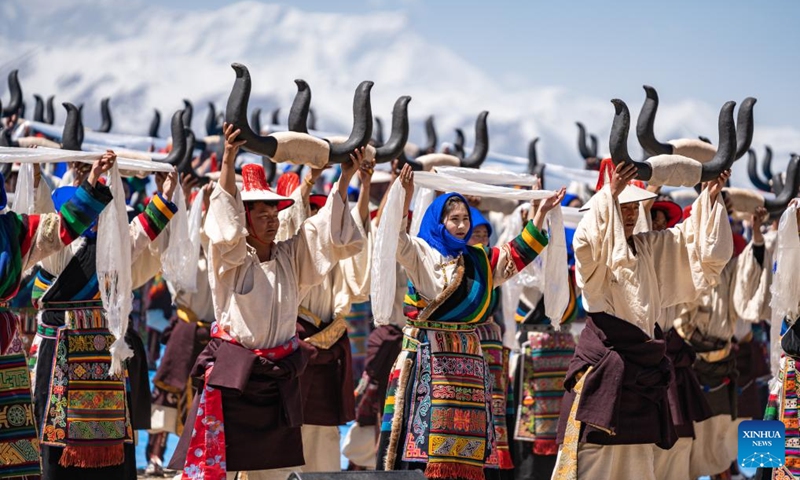 Performers dance at an event celebrating the melting of frozen water of Lake Namtso in southwest China's Xizang Autonomous Region, May 19, 2024. As temperature rises and ice melts, the Lake Namtso will enter its tourism season. Photo: Xinhua