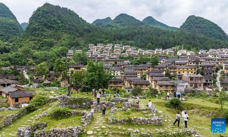 Tourists visit an ancient village in Libo County, southwest China's Guizhou Province, May 16, 2024. Situated on the steep mountainside of Guizhou, Libo County has spectacular views in abundance and has seen a boom in tourism in recent years. Photo: Xinhua