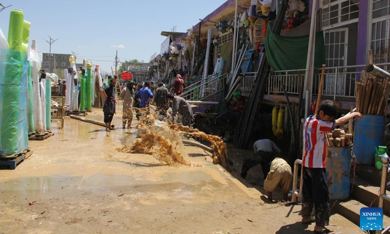 People clear off flood water at the flood-hit area in Firoz Koh in west Afghanistan's Ghor province, May 18, 2024. At least 50 people have been killed, with 10 others missing, in the past 24 hours in west Afghanistan's Ghor Province, a local official said Saturday. Afghanistan has been experiencing heavy rains and floods in the past month, causing casualties and property damage. Photo: Xinhua