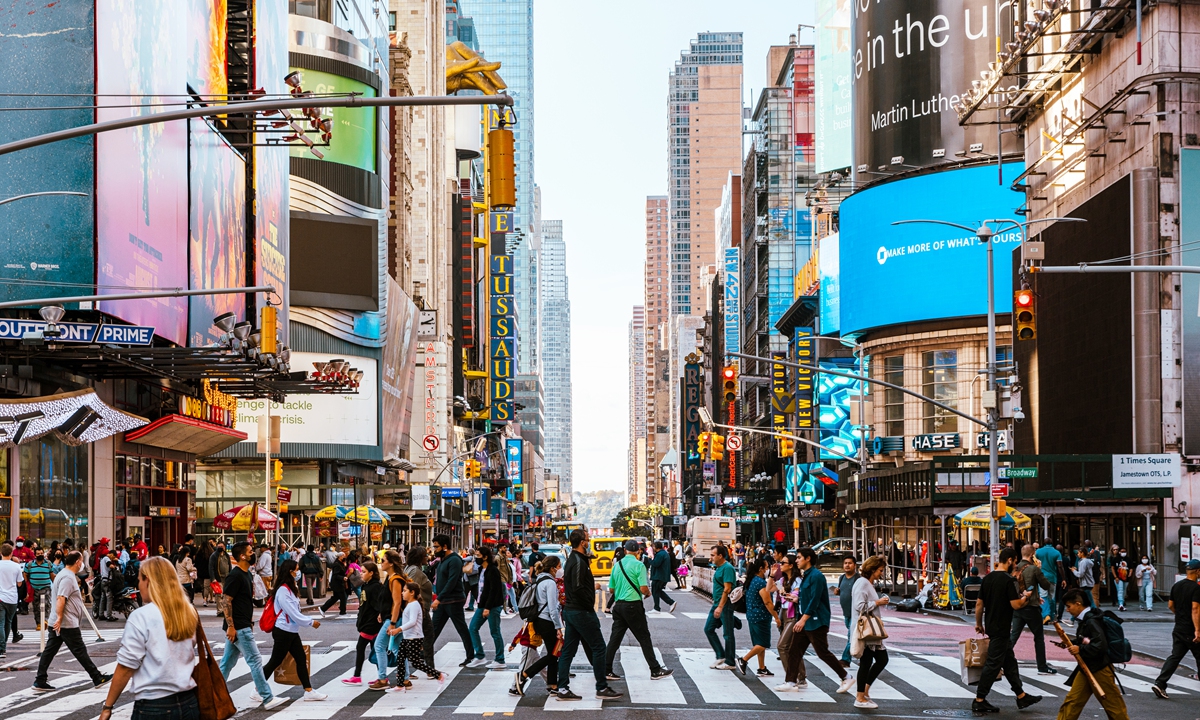 People walk on a street in New York City, the US. Photo： VCG
