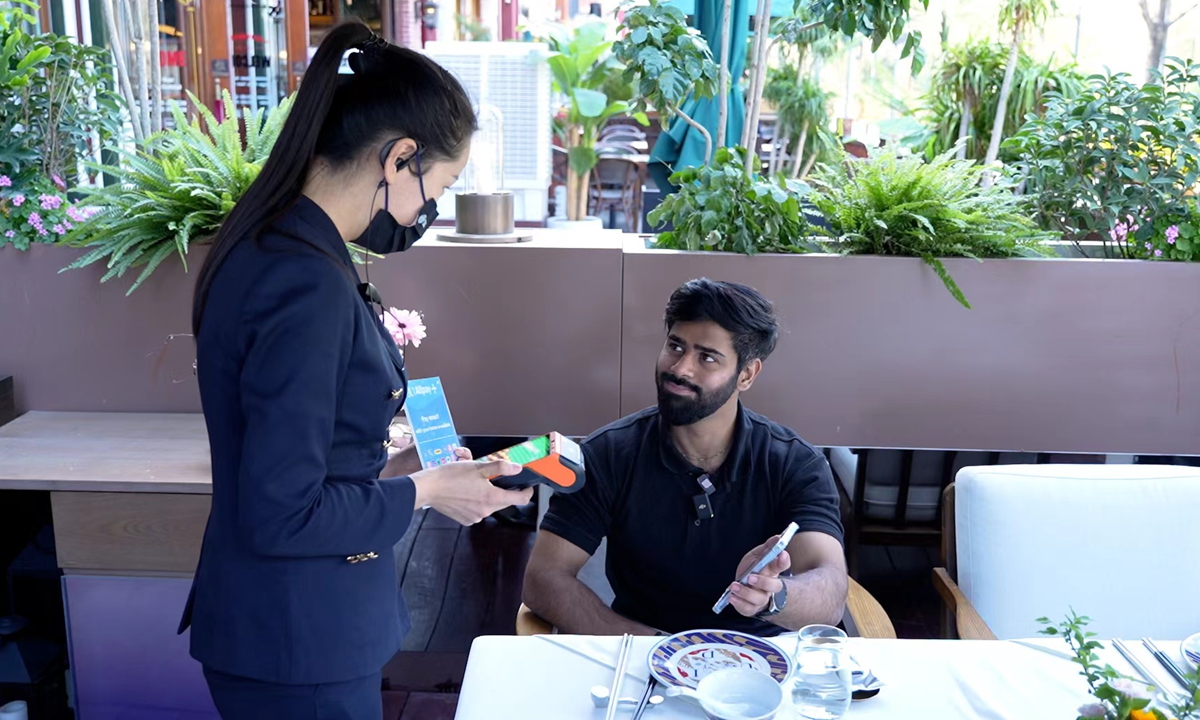 A Pakistani customer pays his bill with Pakistan's NayaPay mobile app in Beijing. Photo: Kang Jie 