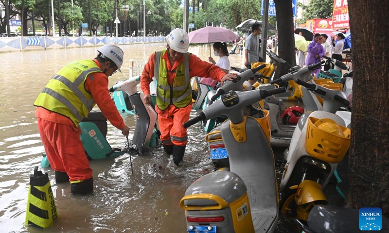 Sanitary workers clean up sewerage facilities on a street in Nanning, south China's Guangxi Zhuang Autonomous Region, May 19, 2024. Heavy rain hit Nanning on Saturday. Photo: Xinhua