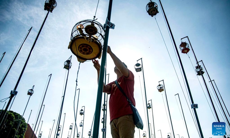 A man prepares for a turtledove chirping contest in Yogyakarta, Indonesia, May 19, 2024. Photo: Xinhua