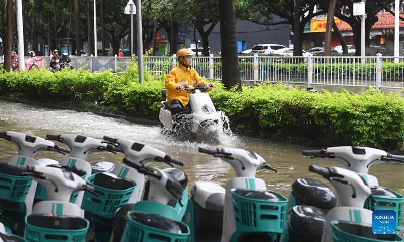 A citizen rides on a waterlogged street in Nanning, south China's Guangxi Zhuang Autonomous Region, May 19, 2024. Heavy rain hit Nanning on Saturday. Photo: Xinhua