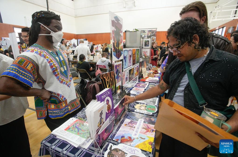 People visit an exhibitor's booth during the 2024 Vancouver Comic Art Festival in Vancouver, British Columbia, Canada, on May 19, 2024. The Vancouver Comic Art Festival, an annual celebration of comics and graphic novels and their creators, including an exhibition and vendor fair, features over one hundred of comic creators from around the world this year. Photo: Xinhua
