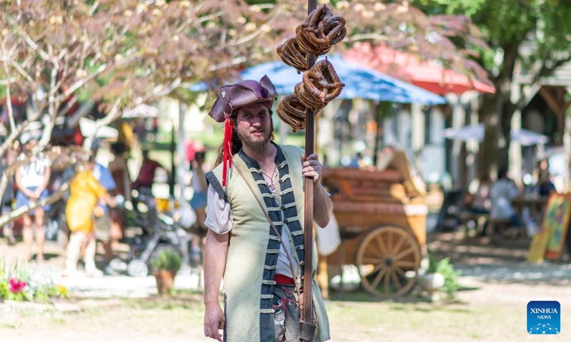 A young man in 16-century costume sells pretzels at the Scarborough Renaissance Festival in Waxahachie, on the outskirts of Dallas, Texas, the United States on May 18, 2024. Photo: Xinhua