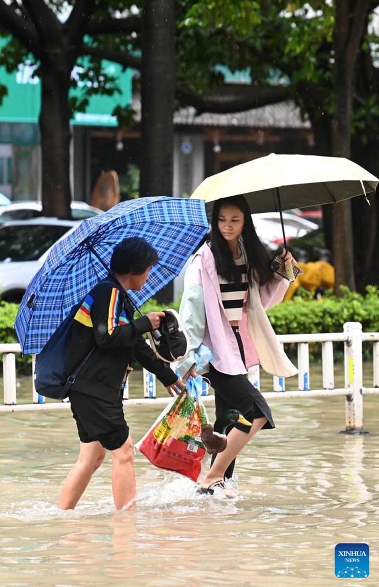 Citizens walk on a waterlogged street in Nanning, south China's Guangxi Zhuang Autonomous Region, May 19, 2024. Heavy rain hit Nanning on Saturday. Photo: Xinhua