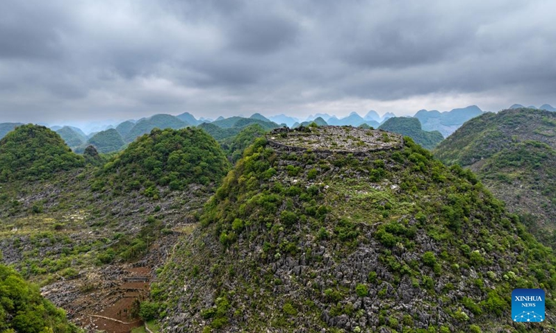 An aerial drone photo taken on May 16, 2024 shows ancient fortifications dating back the Qing Dynasty (1644-1911) on the hilltop in Longan Village of Xingyi City, southwest China's Guizhou Province.(Photo: Xinhua)