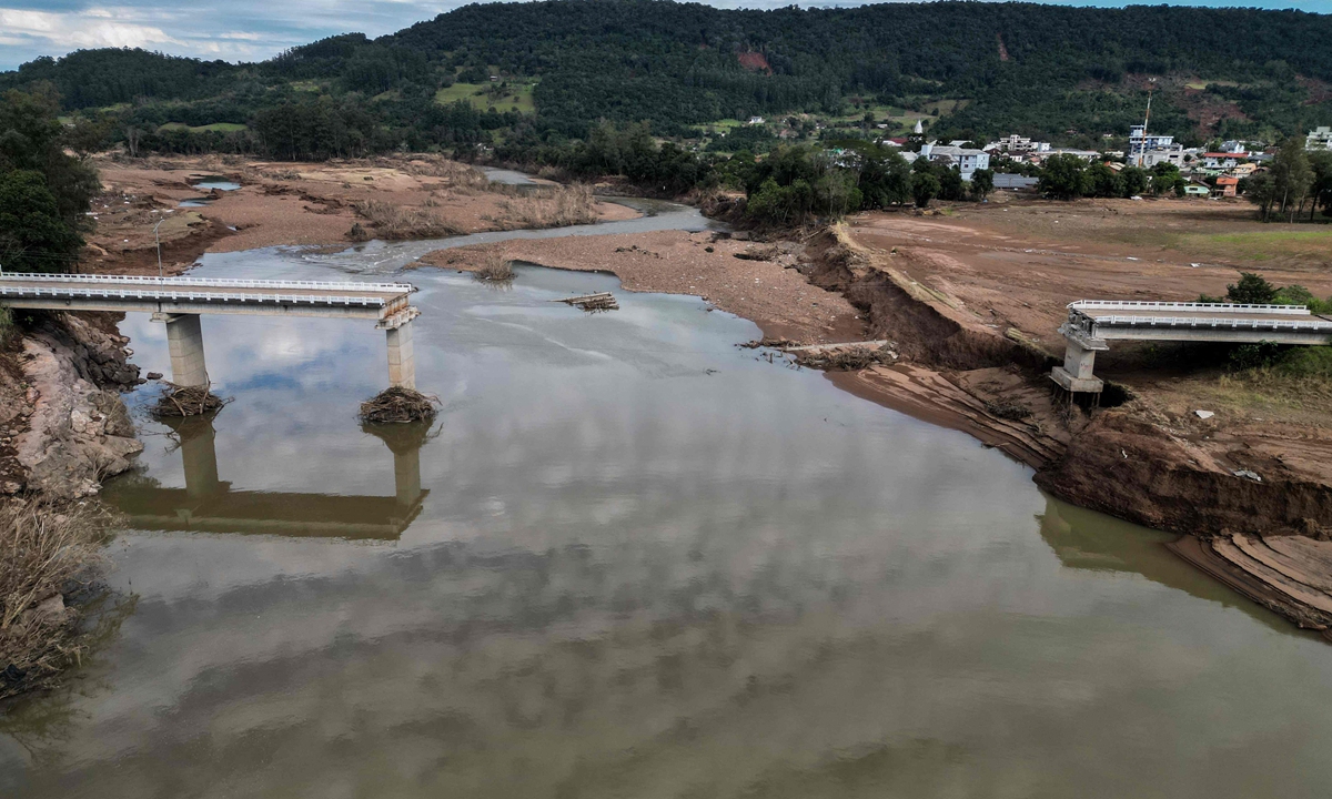 
A destroyed bridge over the Forqueta River hangs between the towns of Marques de Souza and Travesseiro, in Rio Grande do Sul State, Brazil, on May 21, 2024. More than 600,000 people have been displaced by the heavy rain, flooding and mudslides that have ravaged the south of the state for around two weeks. The death toll has risen to 161 due to the extended extreme weather, the Civil Defense agency said.