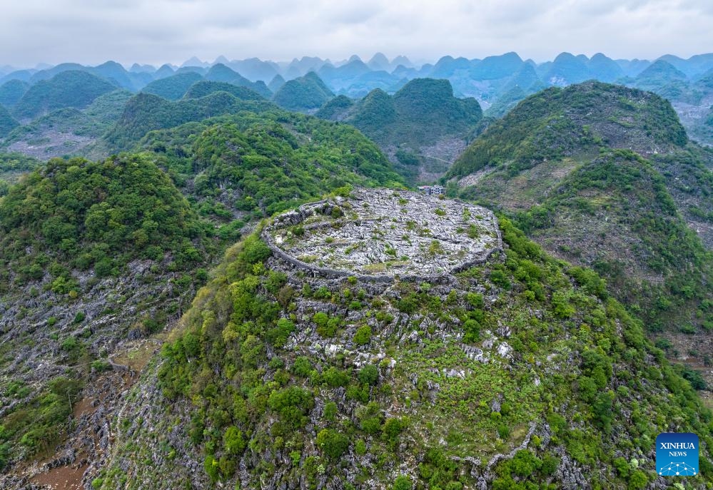 An aerial drone photo taken on May 16, 2024 shows ancient fortifications dating back the Qing Dynasty (1644-1911) on the hilltop in Longan Village of Xingyi City, southwest China's Guizhou Province.(Photo: Xinhua)