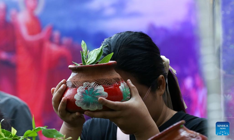 A woman prays on the Fullmoon Day of Kason at the Botahtaung Pagoda in Yangon, Myanmar, May 22, 2024.(Photo: Xinhua)