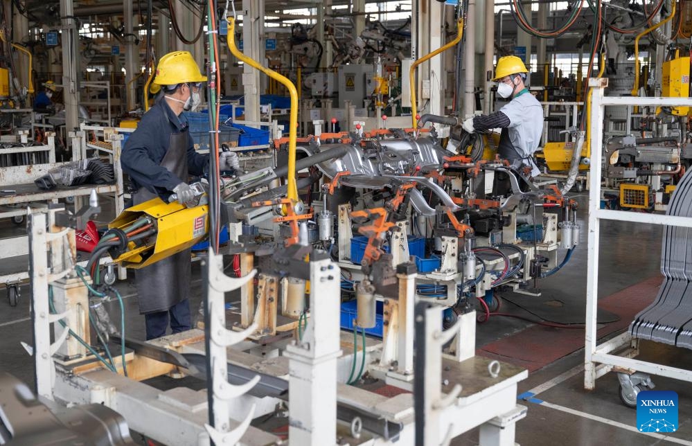 Staff members operate at an assembly line at Wuzheng Group in Wulian County, Rizhao City, east China's Shandong Province, May 23, 2024. Boasting a history dating back to 1961, Wuzheng Group has grown into an important player in China's agricultural and commercial vehicle industry, with about 10,000 staff members and total assets worthing 17 billion yuan (about 2.35 billion US dollars).(Photo: Xinhua)