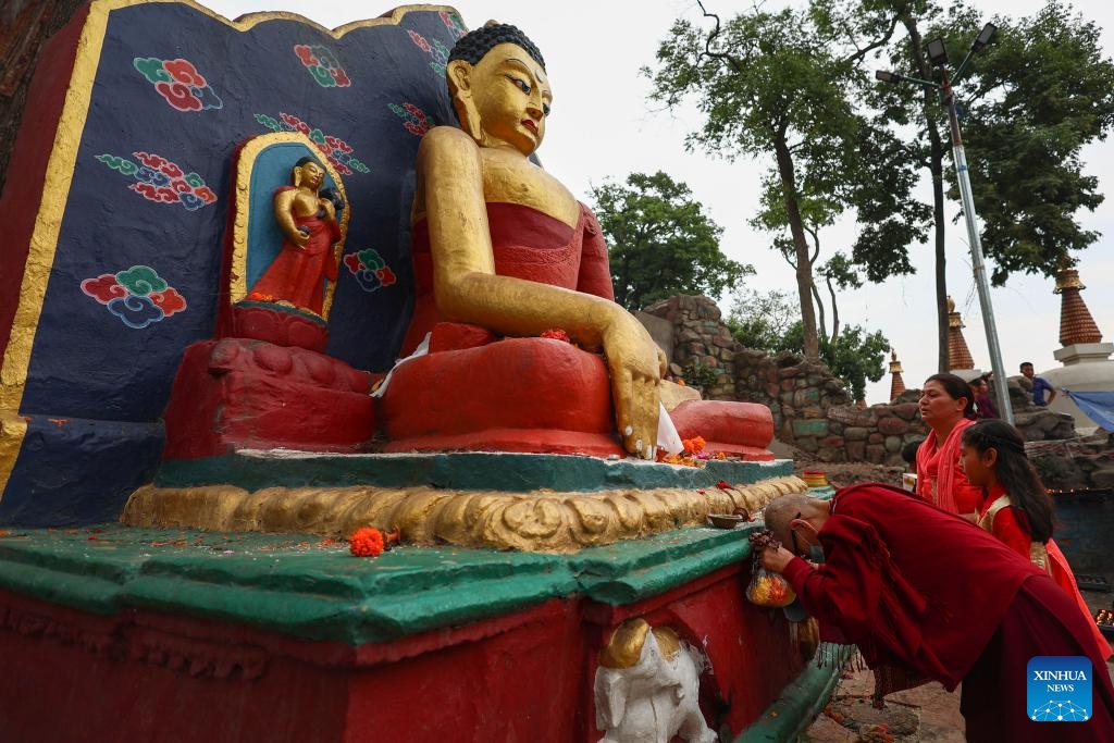 A monk performs a ritual to mark Buddha Jayanti at the Swayambhunath Stupa in Kathmandu, Nepal, May 23, 2024. Every year, Buddha Jayanti is celebrated on the full moon day in the Nepali month of Baishakh marking Buddha's birth, attainment of enlightenment and his death.(Photo: Xinhua)