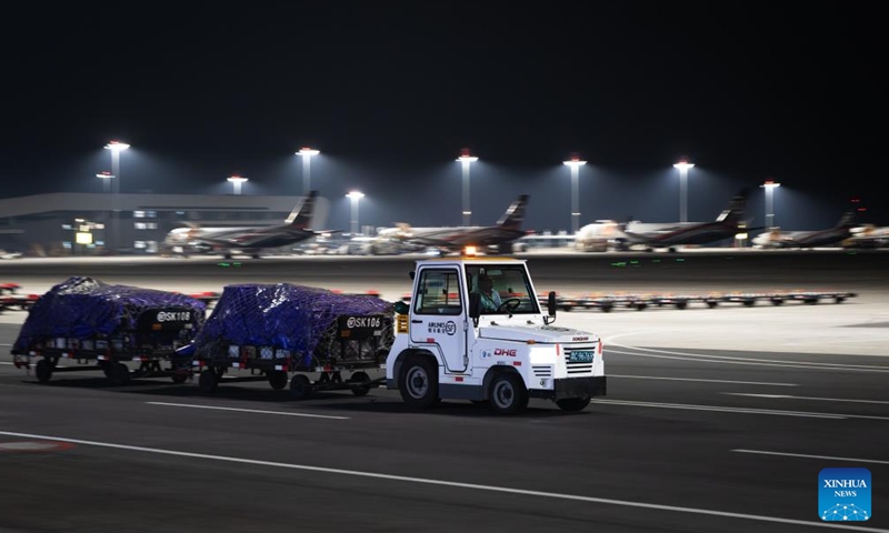 A staff member transfers the cargo at the Ezhou Huahu Airport in Ezhou, central China's Hubei Province, May 25, 2024. The Ezhou Huahu Airport, an all-cargo hub airport starting operations in July 2022, is now running 48 domestic routes and 17 international routes. The airport owns a 750,000-square meter cargo transfer center with parcel sorting lines adding up to 52 kilometers, and its international throughput has exceeded 80,000 tonnes. (Photo:Xinhua)