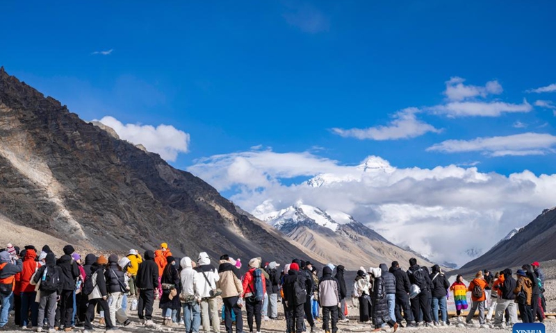 Tourists line up to take photos at the Mount Qomolangma base camp for tourists in Zhaxizom Township of Tingri County in Xigaze City, southwest China's Xizang Autonomous Region, May 24, 2024. The Mount Qomolangma National Park has entered peak tourism season. In 2023, the scenic spot had received about 464,000 tourists, and saw its ticket revenue totaling 110 million yuan (about 15.2 million U.S. dollars). (Photo: Xinhua)