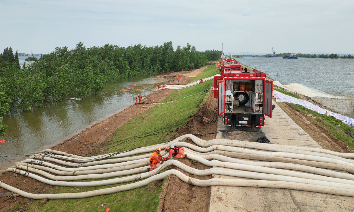 Drainage of standing water in the flooded Tuanzhou dike region, caused by spillover from rain-affected Dongting Lake in Central China’s Hunan Province, is ongoing on the morning of July 9, 2024, after the breached dike was successfully repaired the previous night. Photo: IC