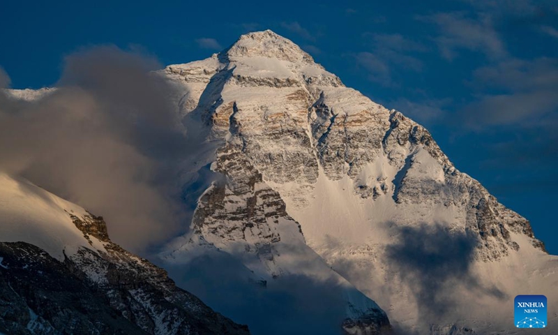 This photo taken on May 21, 2024 shows a view of the Mount Qomolangma at sunset in southwest China's Xizang Autonomous Region. The Mount Qomolangma National Park has entered peak tourism season. In 2023, the scenic spot had received about 464,000 tourists, and saw its ticket revenue totaling 110 million yuan (about 15.2 million U.S. dollars). (Photo: Xinhua)