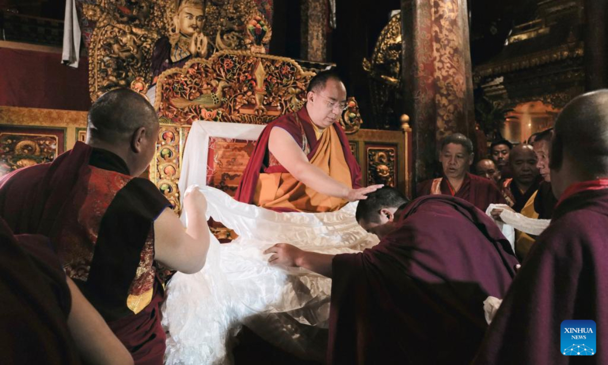 Panchen Erdeni Chos-kyi rGyal-po performs head-touching rituals for monks at Jokhang Temple in Lhasa, the capital of southwest China's Xizang Autonomous Region, June 28, 2024. Panchen Rinpoche on Friday visited Jokhang Temple, the most revered monastery in Lhasa, the capital of southwest China's Xizang Autonomous Region. During his visit, which lasted about an hour, Panchen Rinpoche participated in religious services and performed head-touching rituals for monks at the temple. (Photo: Xinhua)