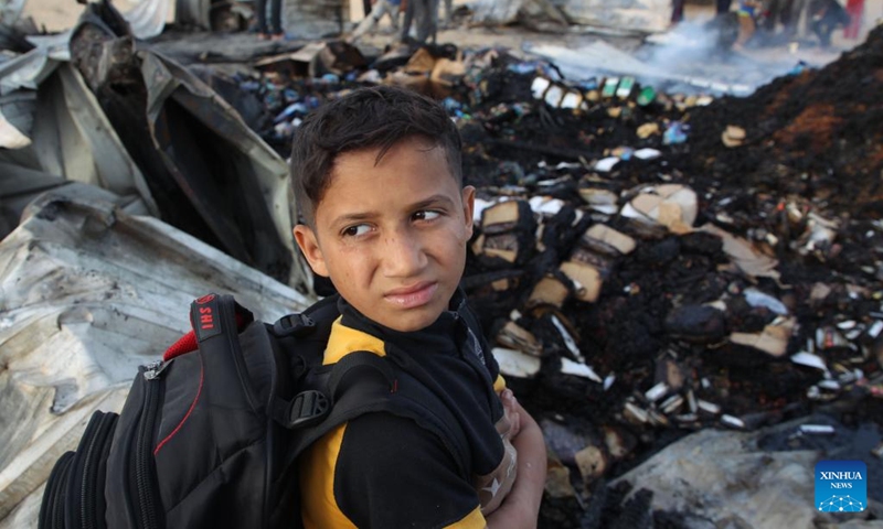 A person looks on at the site of an Israeli strike on a camp for displaced people in Rafah in the southern Gaza Strip, May 27, 2024. At least 40 people were killed and some others injured on Sunday evening in Israel's bombing of tents in northwestern Rafah, the southernmost city of the Gaza Strip, the Palestinian official news agency WAFA reported.(Photo: Xinhua)