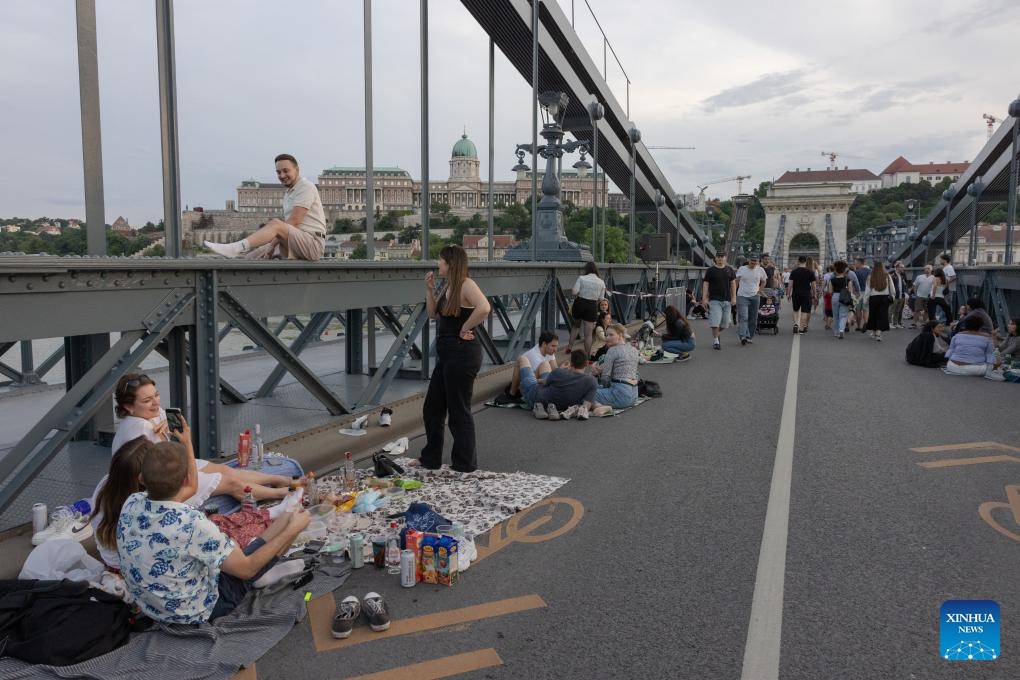 People participate in the Chain Bridge picnic event in celebration of the 175th anniversary of the landmark bridge in Budapest, Hungary on May 26, 2024.(Photo: Xinhua)