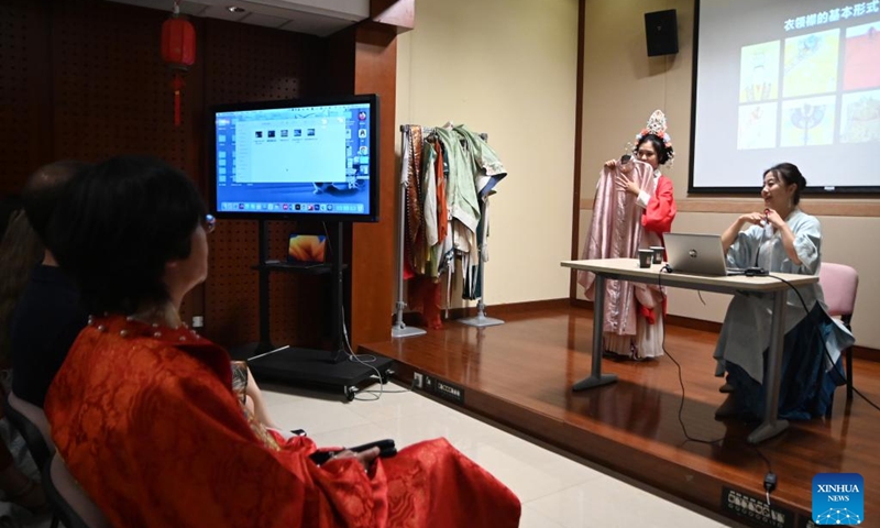 Chu Yan (R), a professor at the Beijing Institute of Fashion Technology, gives a lecture titled Chinese Stories -- Dialogue with the World through the Beauty of Chinese Clothing in Valletta, capital of Malta, on May 27, 2024.(Photo: Xinhua)