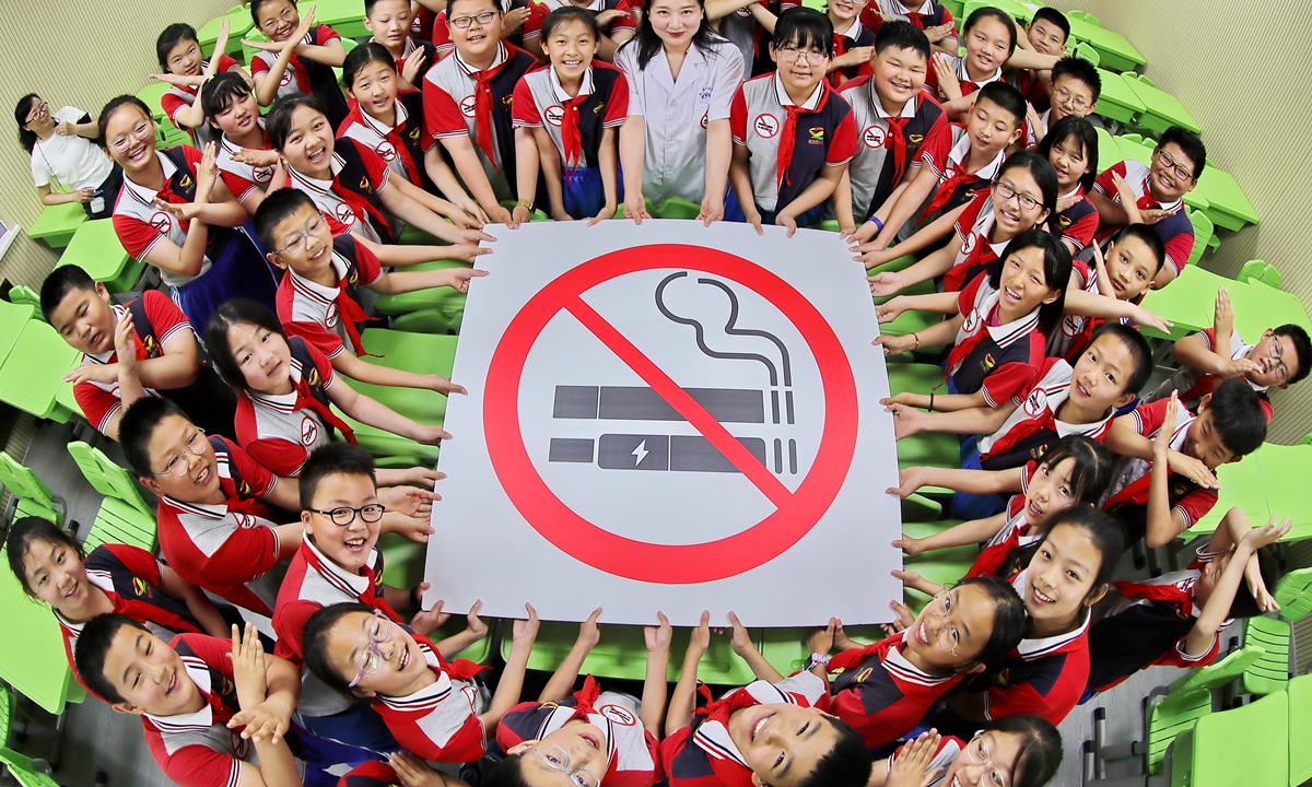On May 30, 2024, a representative from the Center for Disease Control and Prevention in Qinhuangdao, North China's Hebei Province, and local students take a group photo with a no-smoking sign to welcome World No Tobacco Day which falls on May 31. Photo: VCG