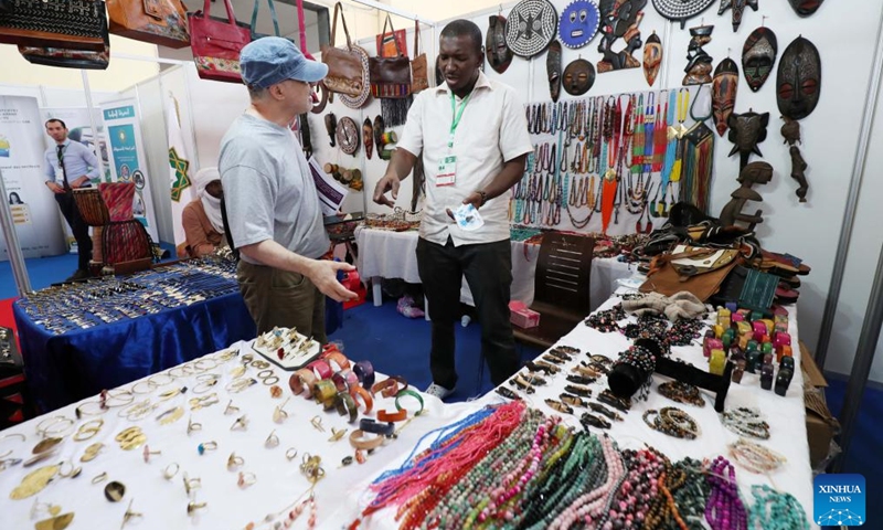 An exhibitor (R) talks with a visitor at the International Tourism and Travel Exhibition in Algiers, Algeria, on May 31, 2024. This exhibition is held in Algiers from May 30 to June 2. (Xinhua)