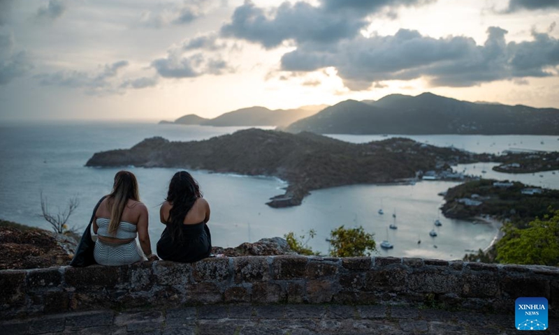 Tourists enjoy sunset at Shirley Heights in Antigua and Barbuda, May 29, 2024. (Xinhua/Li Muzi)