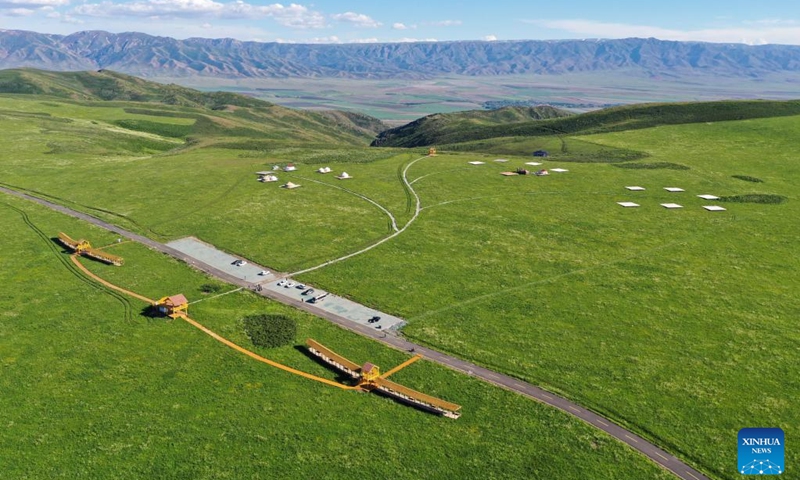 An aerial drone photo taken on May 30, 2024 shows a grassland scenic spot in Emin County, Tacheng Prefecture, northwest China's Xinjiang Uygur Autonomous Region. Xinjiang in northwest China has entered its peak tourism season recently. Emin County, located near the China-Kazakhstan border, is a popular tourist destination which provides various rural tour routes and cultural events. (Photo: Xinhua)