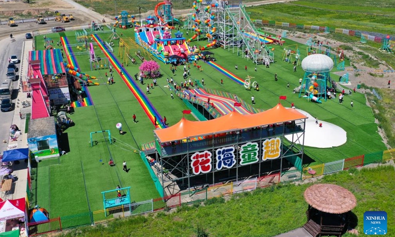 An aerial drone photo taken on May 30, 2024 shows a countryside amusement park in Emin County, Tacheng Prefecture, northwest China's Xinjiang Uygur Autonomous Region. Xinjiang in northwest China has entered its peak tourism season recently. Emin County, located near the China-Kazakhstan border, is a popular tourist destination which provides various rural tour routes and cultural events. (Photo: Xinhua)