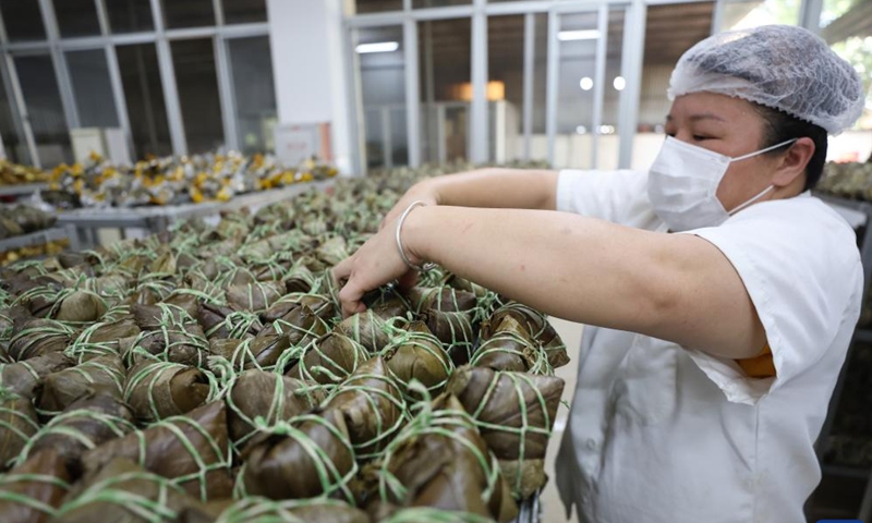 A worker arranges Zongzi at a food company in Ding'an County, south China's Hainan Province, June 2, 2024. (Photo: Xinhua)