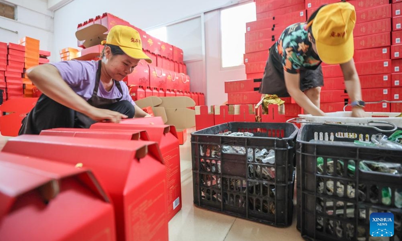Workers pack Zongzi at a food company in Ding'an County, south China's Hainan Province, June 2, 2024. (Photo: Xinhua)