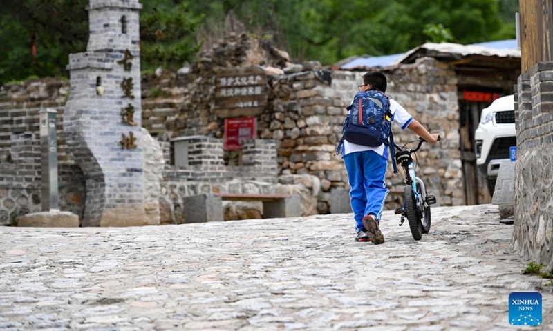 A boy walks past the relic site of an ancient fort in Shixia Village in Yanqing District of Beijing, capital of China, May 31, 2024. Shixia Village in Yanqing District of Beijing was first built in the Ming Dynasty (1368-1644) and was once an important pass in the north of Juyongguan section of the Great Wall. (Photo: Xinhua)