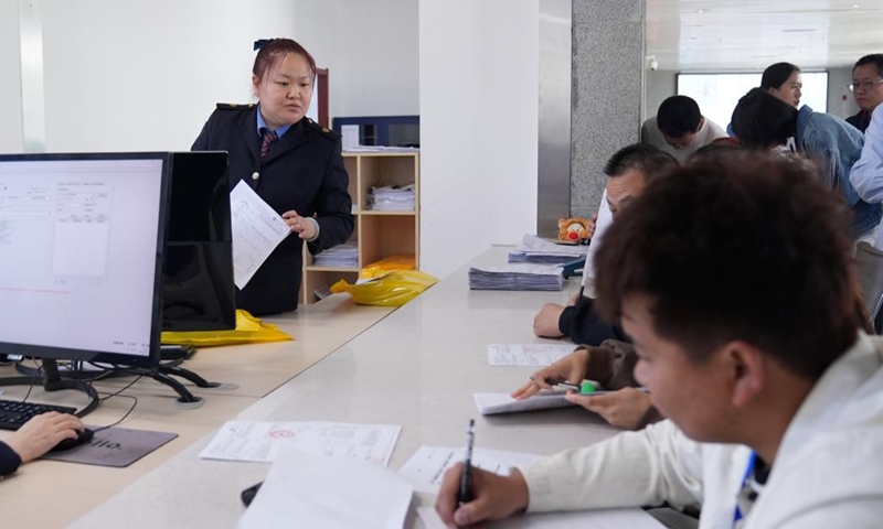 A staff member processes international transportation documents for clients at Horgos Port in Horgos, northwest China's Xinjiang Uygur Autonomous Region, May 29, 2024. The Horgos Port and the Alataw Pass, two major railway ports in northwest China's Xinjiang Uygur Autonomous Region, have handled more than 6,400 China-Europe (Central Asia) freight train trips since the beginning of this year, according to China Railway Urumqi Group Co., Ltd. (Photo: Xinhua)