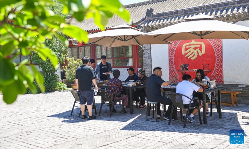 Visitors have a meal in Shixia Village in Yanqing District of Beijing, capital of China, June 1, 2024. Shixia Village in Yanqing District of Beijing was first built in the Ming Dynasty (1368-1644) and was once an important pass in the north of Juyongguan section of the Great Wall. (Photo: Xinhua)