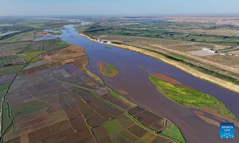 An aerial drone photo taken on May 30, 2024 shows the paddy fields along the Yellow River in Yinchuan, northwest China's Ningxia Hui Autonomous Region. This rice planting season has drawn to an end. Abundant supply of water and sunshine in June injects extra vigor into these newly planted seedlings. (Photo: Xinhua)