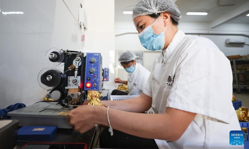 A worker packs Zongzi at a food company in Ding'an County, south China's Hainan Province, June 2, 2024. (Photo: Xinhua)