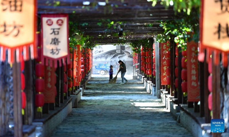 A villager sweeps a lane in the morning in Shixia Village in Yanqing District of Beijing, capital of China, June 1, 2024. Shixia Village in Yanqing District of Beijing was first built in the Ming Dynasty (1368-1644) and was once an important pass in the north of Juyongguan section of the Great Wall. (Photo: Xinhua)