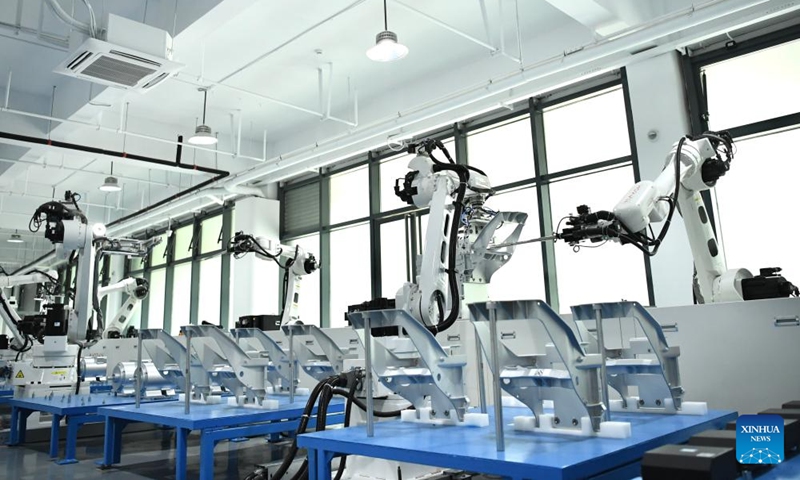 This photo taken on June 1, 2024 shows automated robot arms working at a workshop of Horwin in Changzhou, east China's Jiangsu Province. Founded in 2016, Horwin is a pioneering manufacturer of intelligent electric motorcycles, primarily targeting the overseas market. Boasting over 200 core technology patents, Horwin's electric motorcycles are sold in more than 100 countries and regions. (Photo: Xinhua)