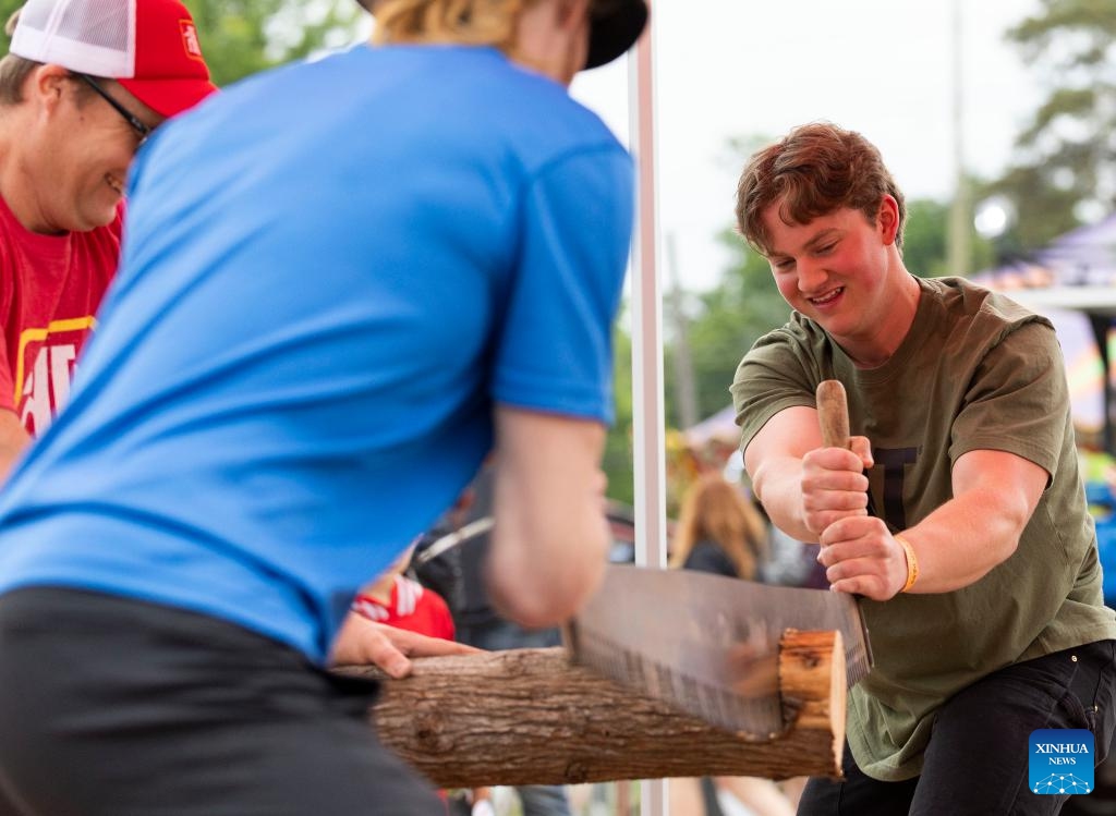 Participants compete during the Nail Driving & Log Saw Competition at the Brooklin Spring Fair in Brooklin, Ontario, Canada, on June 2, 2024.(Photo: Xinhua)