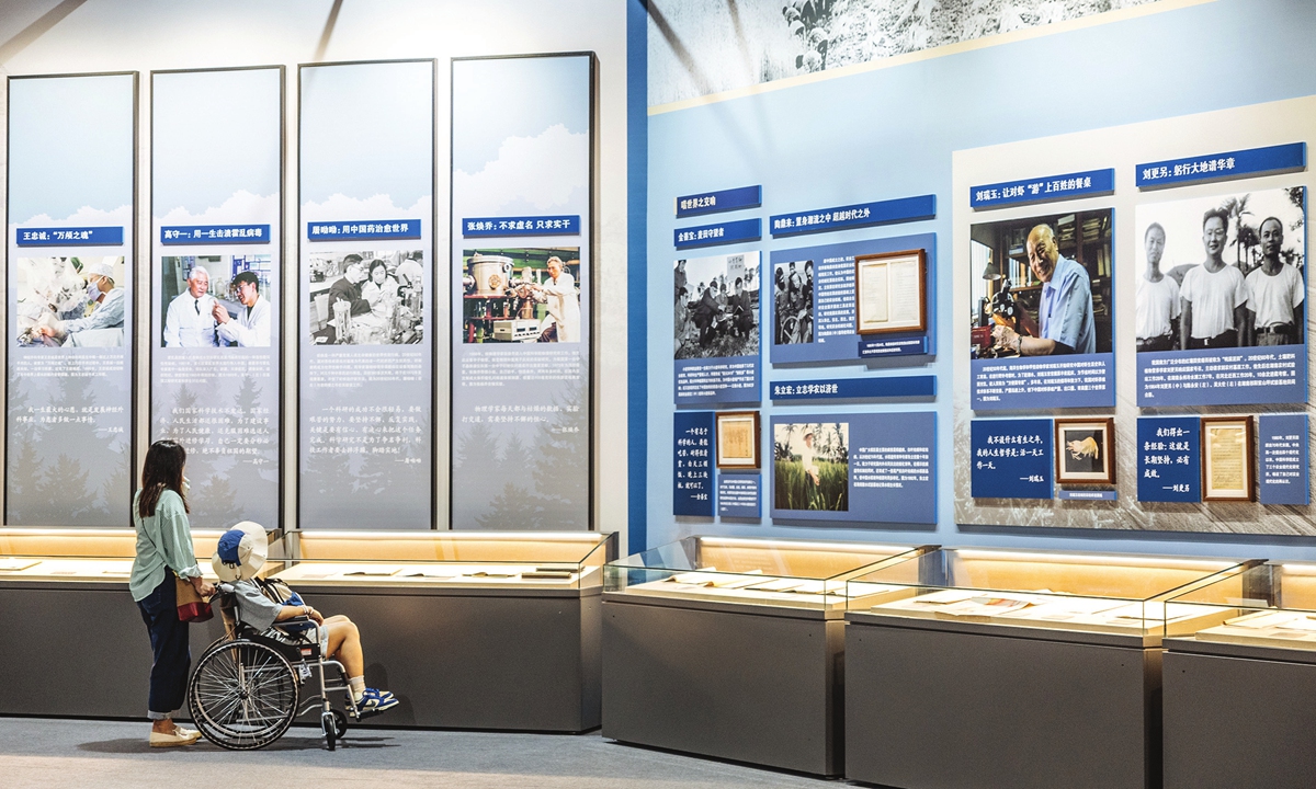 Visitors explore photos of Chinese scientists and read their stories at the National Museum for Modern Chinese Scientists in Beijing on Thursday. Photo: Li Hao/GT