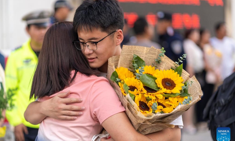 A student hugs his mother after the exam at a national college entrance examination site in Dali Bai Autonomous Prefecture, southwest China's Yunnan Province, June 8, 2024. 
