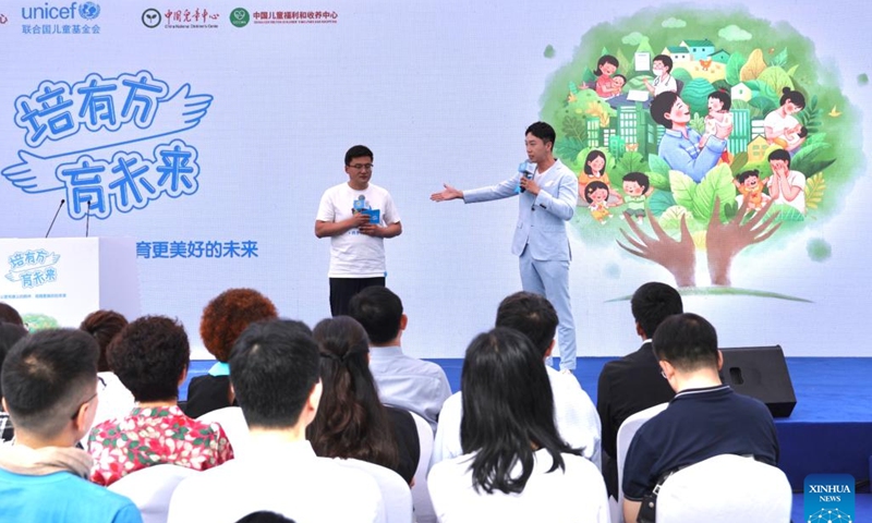 A volunteer from northwest China's Gansu Province shares his experience during a public campaign held in Beijing, capital of China, June 7, 2024.