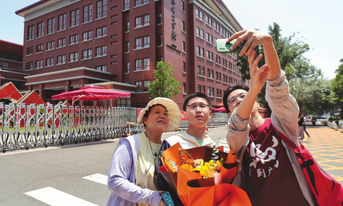A student takes a photo with his family after completing the annual national college entrance examinations, also known as <em>Gaokao</em>, at Beijing National Day School on June 10, 2024 in Beijing. The annual national college entrance examinations held in Beijing ended on Monday. Photo: Li Hao/GT