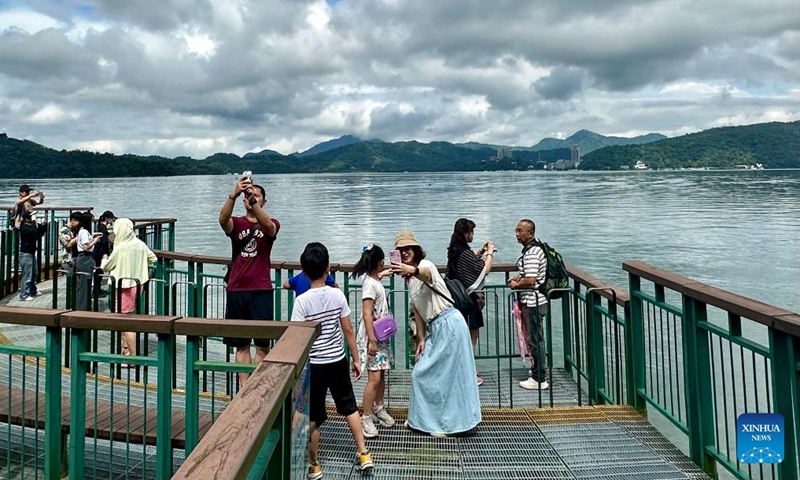 Tourists visit the scenic spot of Riyue Tan, or the Sun Moon Lake, during the holiday of the Dragon Boat Festival, also called Duanwu Festival, in Nantou County, southeast China's Taiwan, June 9, 2024. (Photo: Xinhua)