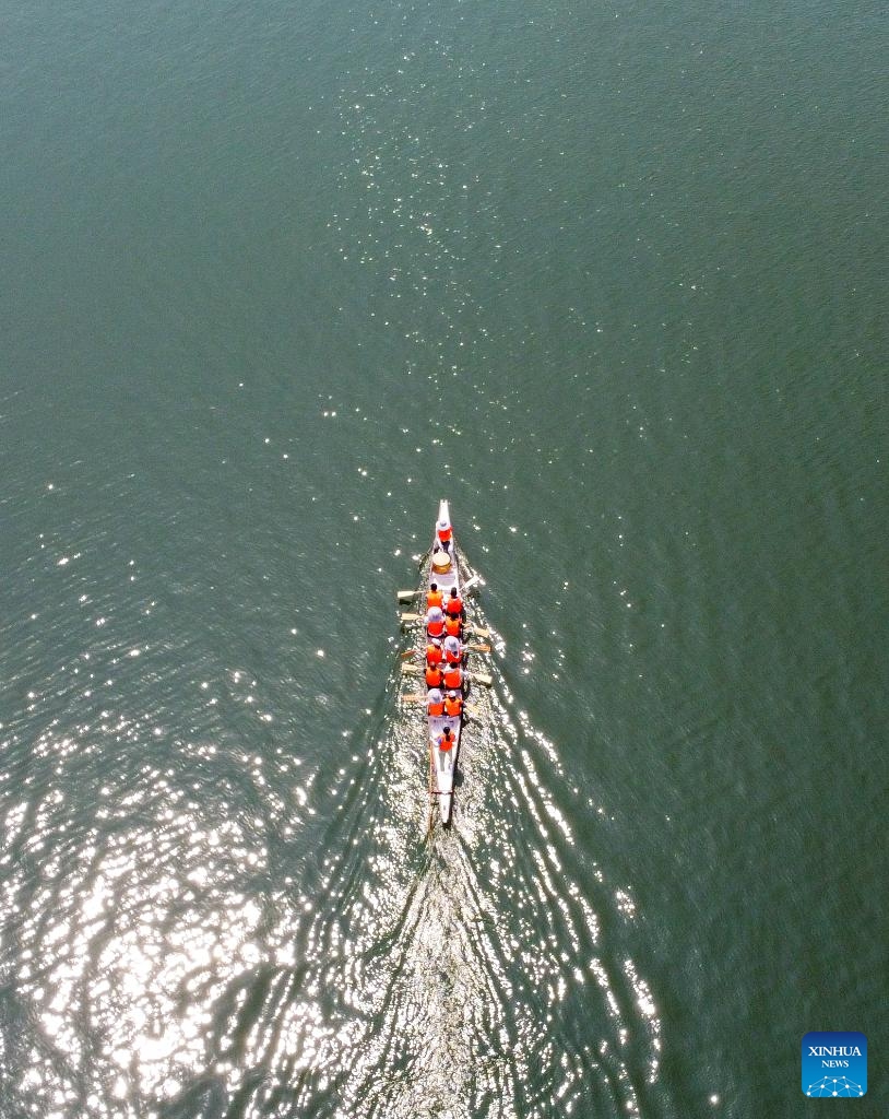 An aerial photo taken on June 6, 2024 shows Laura Mora, a Spanish engineer from Airbus China, and her teammates of Airbus China dragon boat team practise on the Haihe river in north China's Tianjin. (Photo: Xinhua)