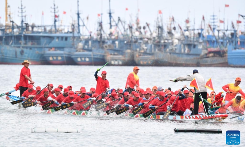 Contestants participate in a dragon boat race at a fishing port in Lianjiang County, southeast China's Fujian Province, June 11, 2024. (Photo: Xinhua)