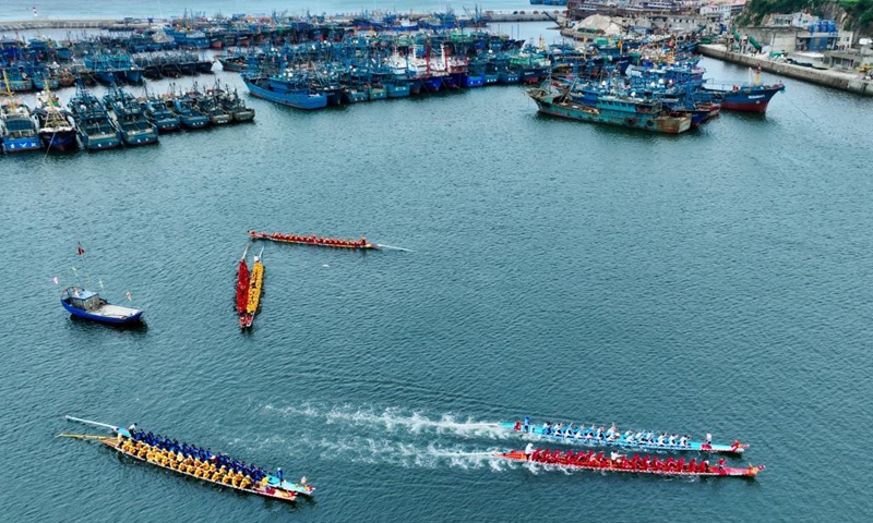 An aerial drone photo shows contestants participating in a dragon boat race at a fishing port in Lianjiang County, southeast China's Fujian Province, June 11, 2024. (Photo: Xinhua)