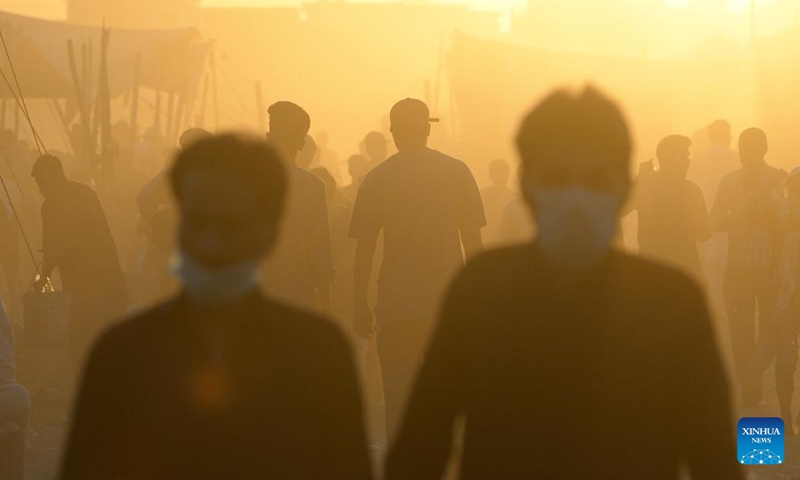 People visit a livestock market ahead of Eid al-Adha festival in Islamabad, capital of Pakistan on June 11, 2024. (Photo: Xinhua)