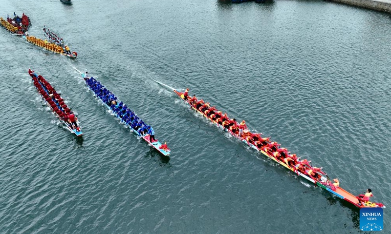 An aerial drone photo shows contestants participating in a dragon boat race at a fishing port in Lianjiang County, southeast China's Fujian Province, June 11, 2024. (Photo: Xinhua)